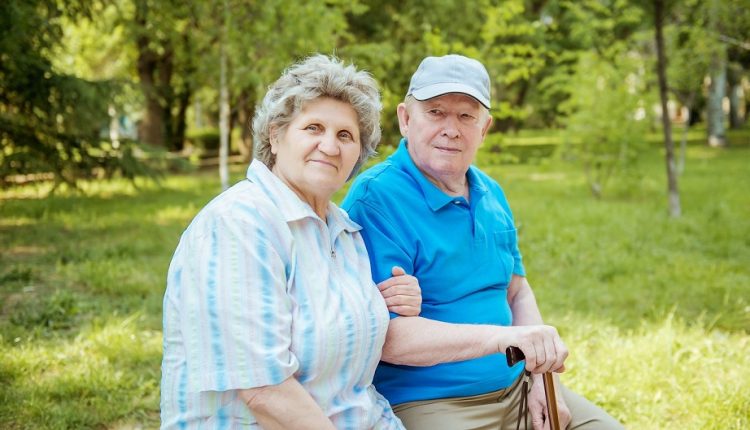 an old couple sitting in a park