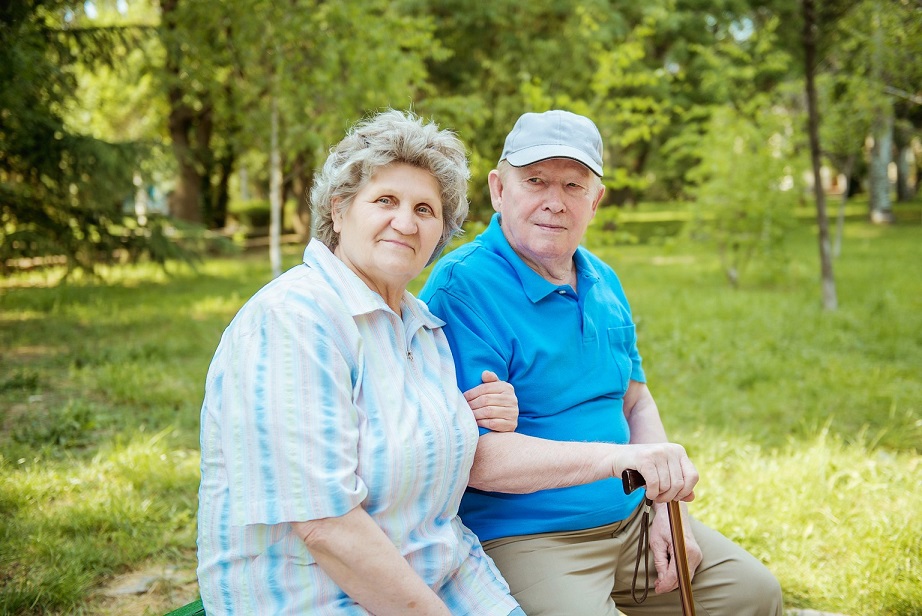 an old couple sitting in a park