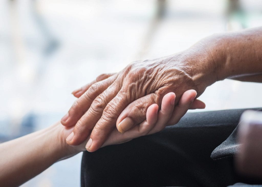 holding a young and an old hand 