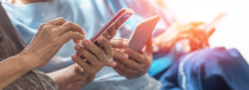 3 seniors hands holding their smartphones.