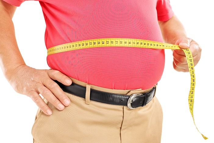 A old man is measuring his belly with a meter. Over-size senior.