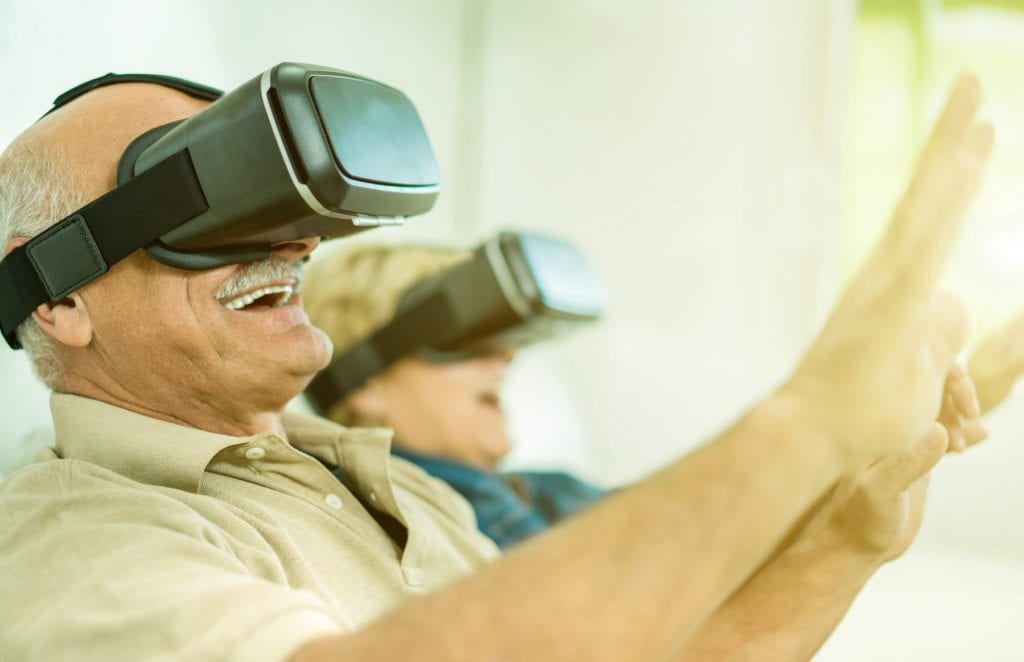 A senior couple are using VR headset. they are enjoying their virtual journey