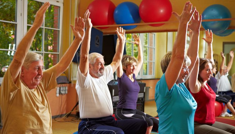 A group of seniors are playing sport like Pilates