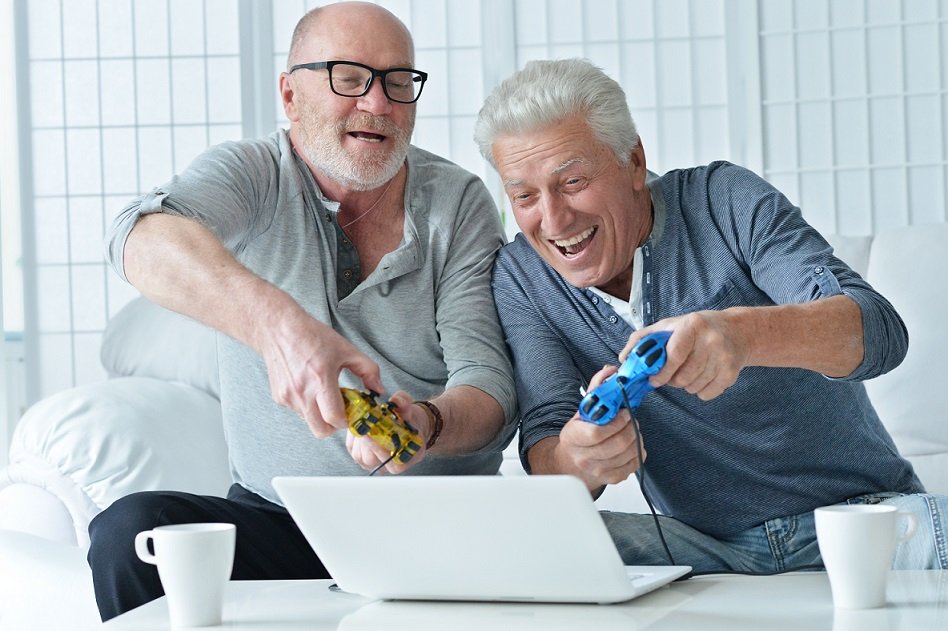 two old men are playing computer game.