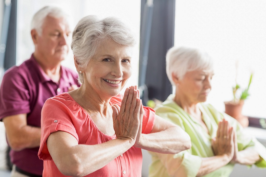 older adults in a yoga class. Happiness and health for seniors in yoga class