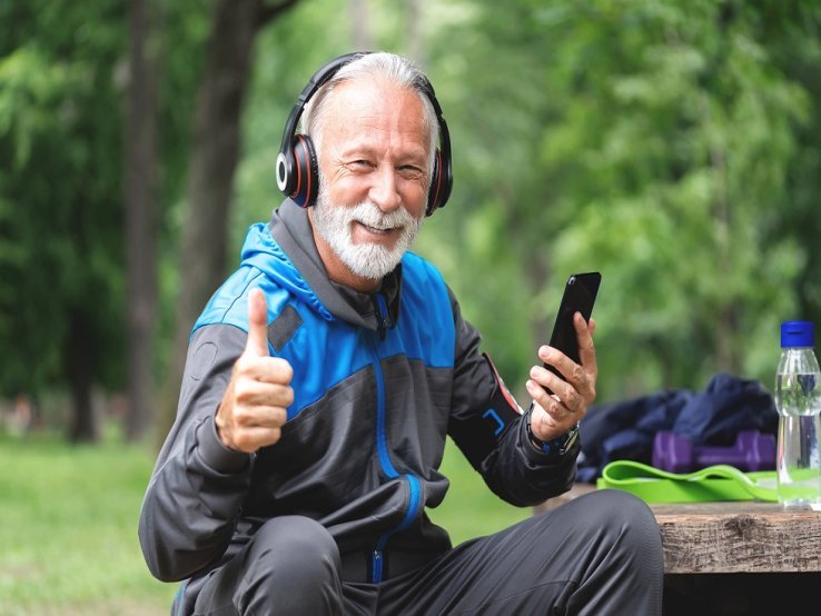 A senior man is listening to music during exercise.