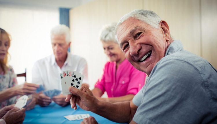 Seniors are playing cards and are entertained