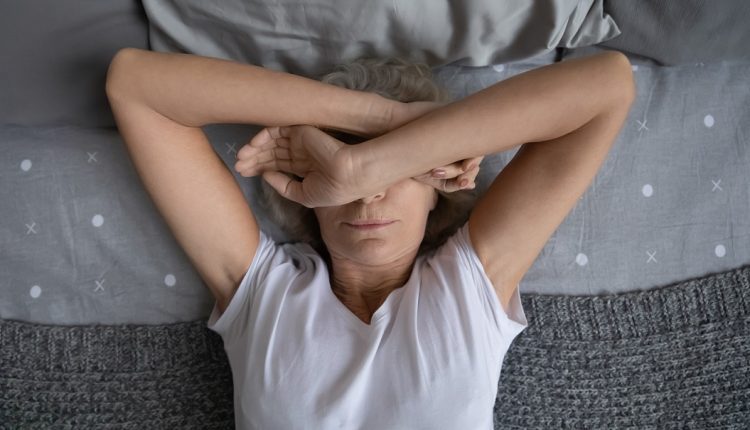 elderly female cover face with hands suffers from Mental disorder