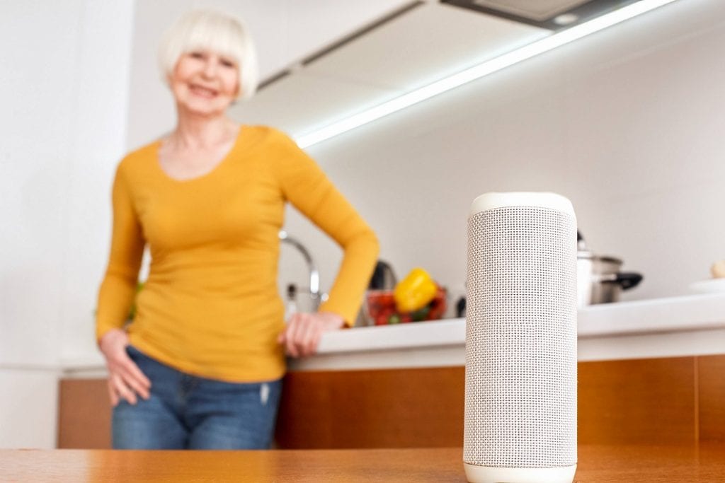 A senior woman is listening to music in her smart home