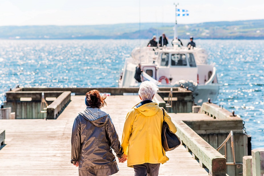 two old senior friends are walking near sea.