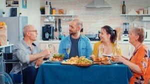 Elderly man with disability having good conversation with his family