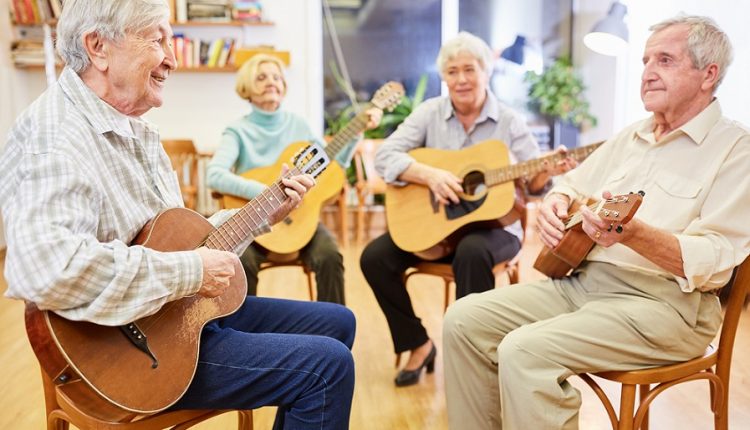 A group of seniors are playing guitar. Music is very important in old age