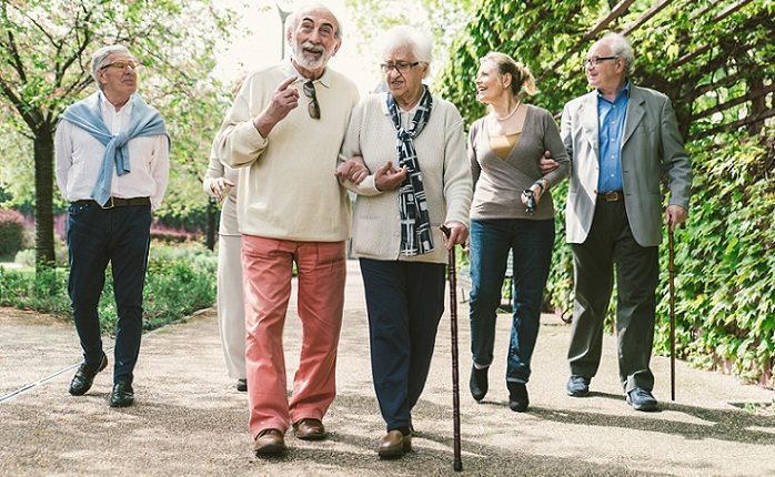 Group of old people walking in a park