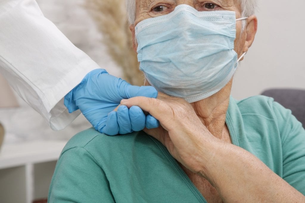 the elderly woman wearing protective medical mask to avoid Cvid-19