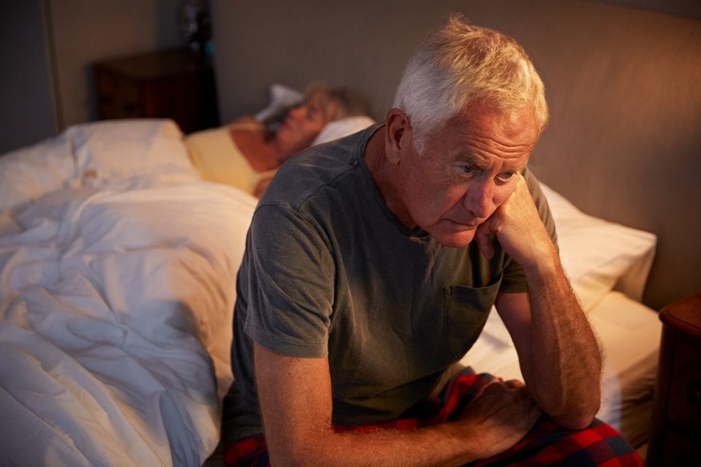 Worried Senior Man In Bed At Night Suffering With Insomnia and sleep disorder