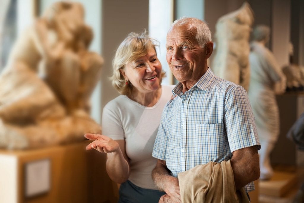 elderly couple looking at museum , they are entertained