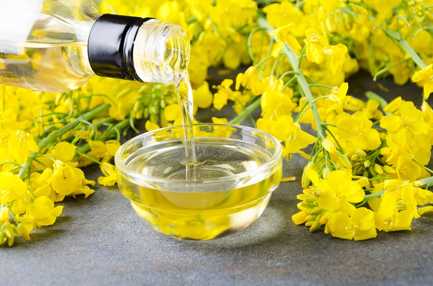 Canola oil is being poured into a bowl
