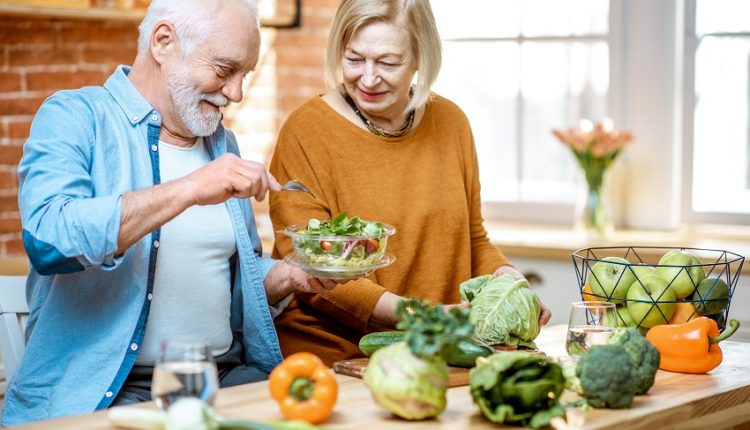 A senior couple making food