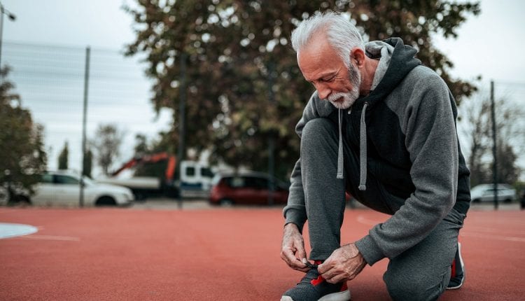 senior man fixing her shoes before exercise