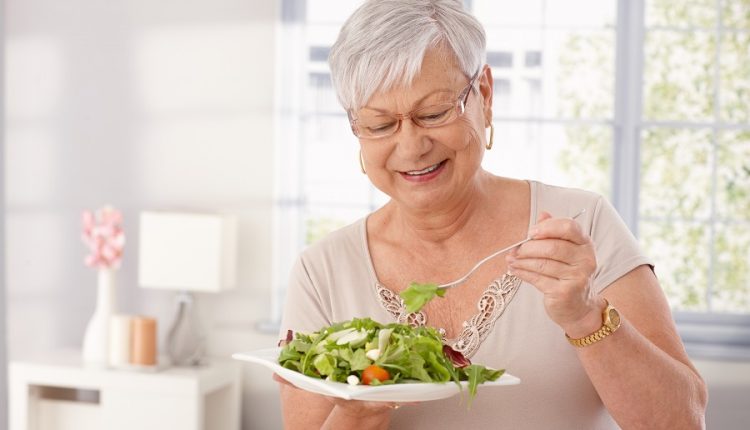 A senior woman eating food