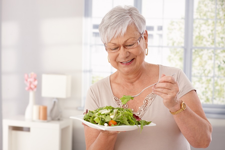 A senior woman eating food