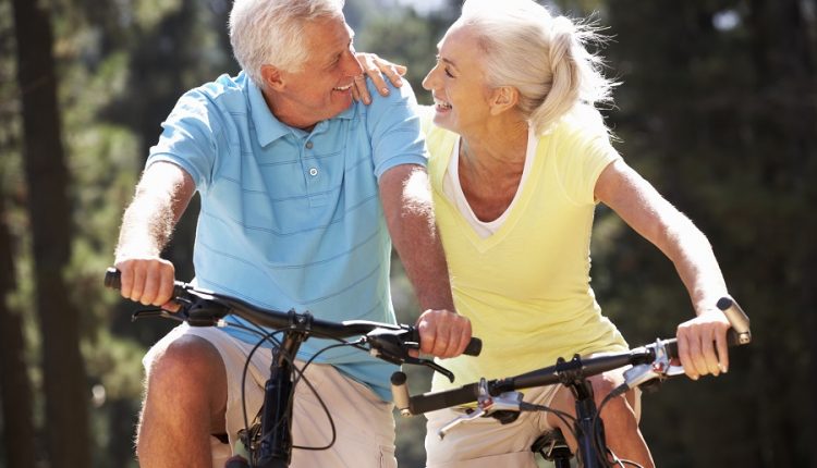 Two happy seniors riding bikes