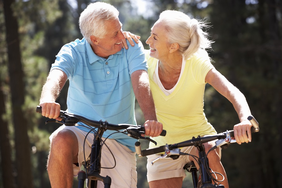 Two happy seniors riding bikes