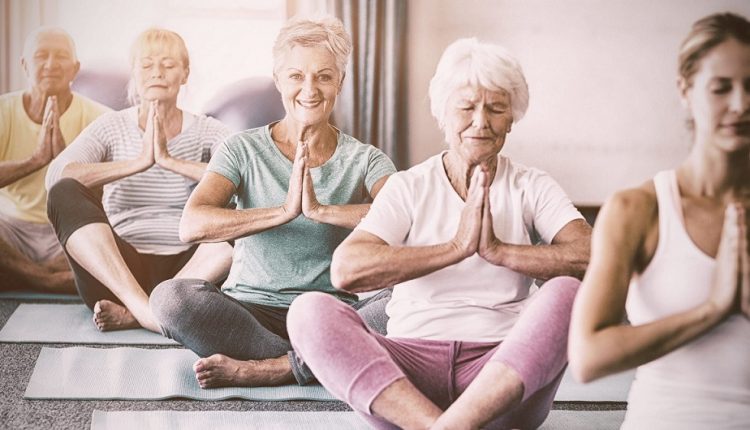 A group of seniors doing exercises in a class