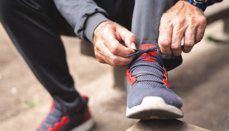 Senior man tying shoelace