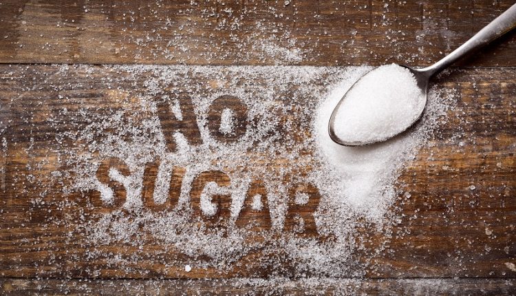 No sugar written by sprinkled sugar on a wooden table