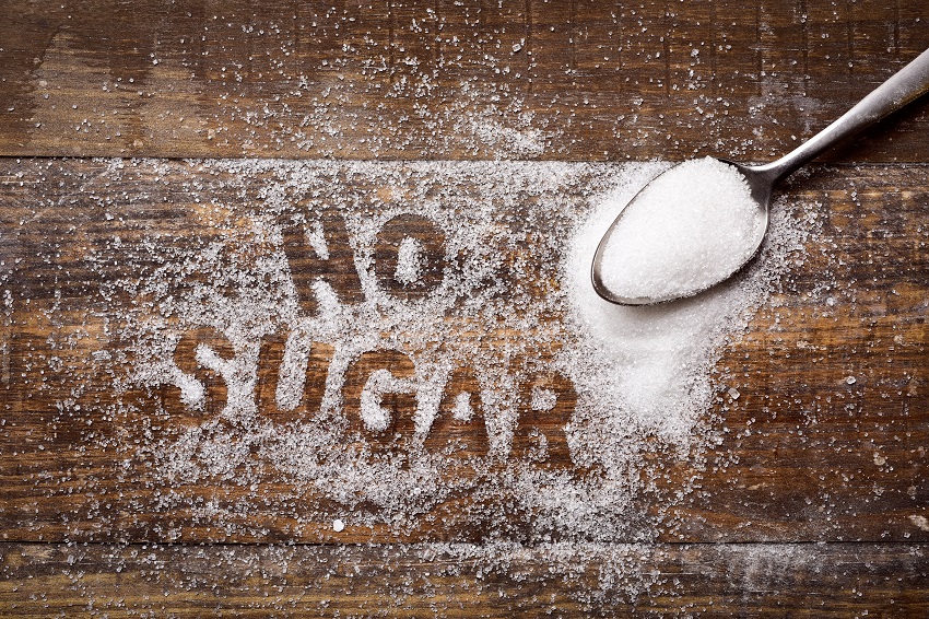 No sugar written by sprinkled sugar on a wooden table