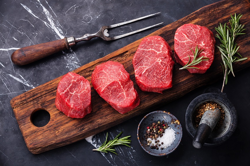 Raw fresh marbled meat Steak and seasonings on dark marble background