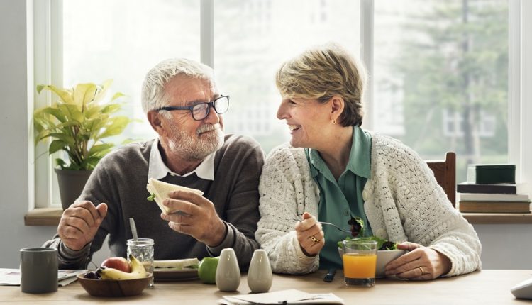 senior couple eating breakfast at a table