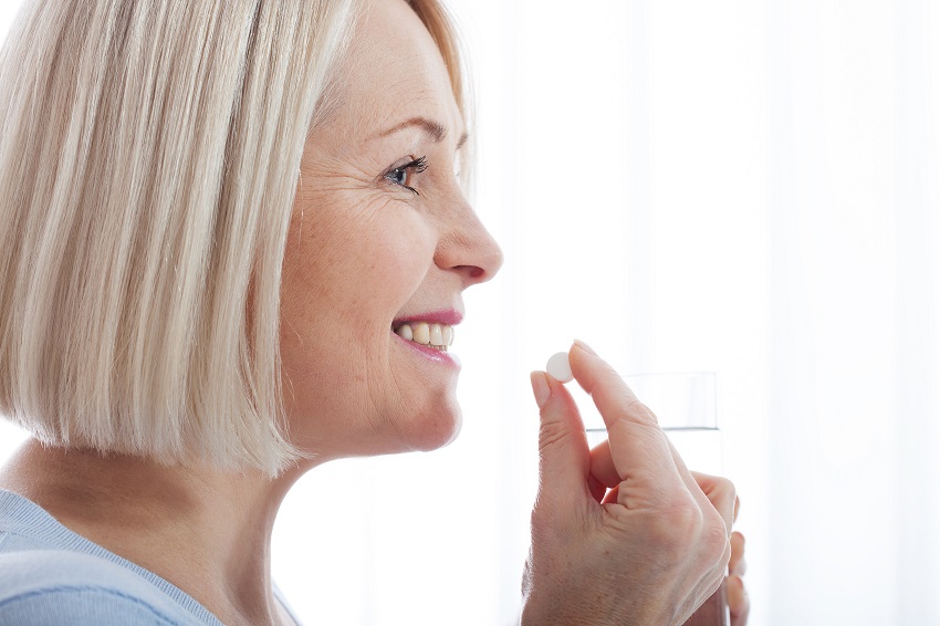 a senior woman taking pills