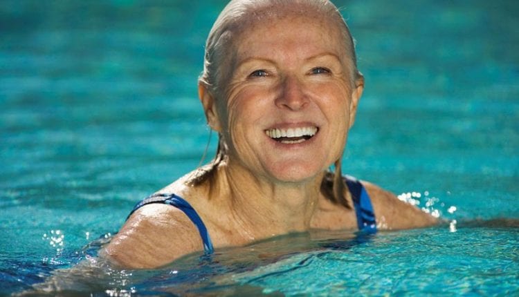 Fit active senior woman smiling in a swimming pool