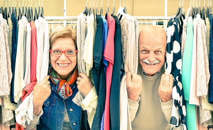 a senior couple between clothes