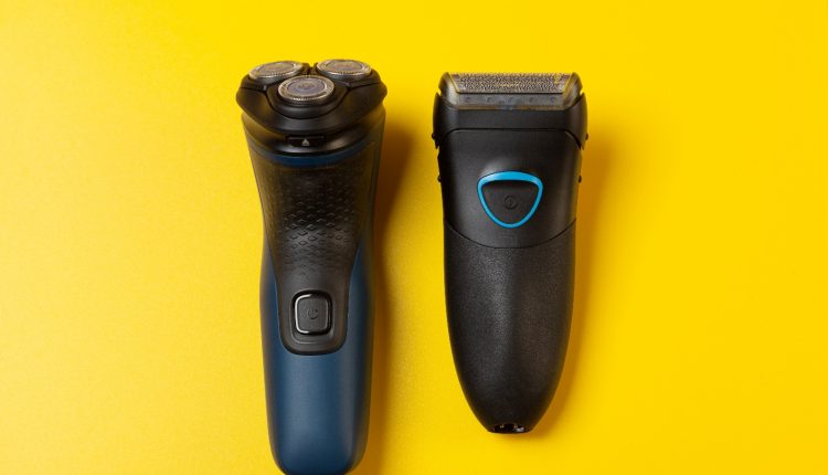 Two electric razors on a yellow background