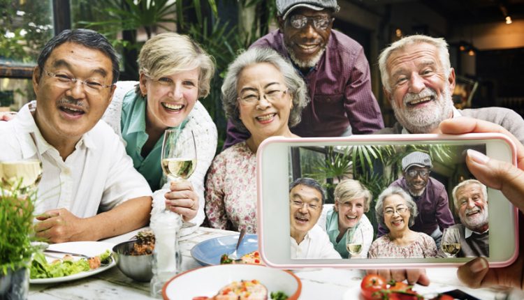 A group of seniors in a retirement party posing for a picture