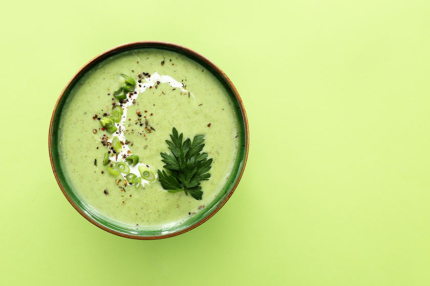 Bowl of tasty cream ketogenic soup on colour background