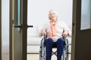 A senior woman sitting on a wheelchair