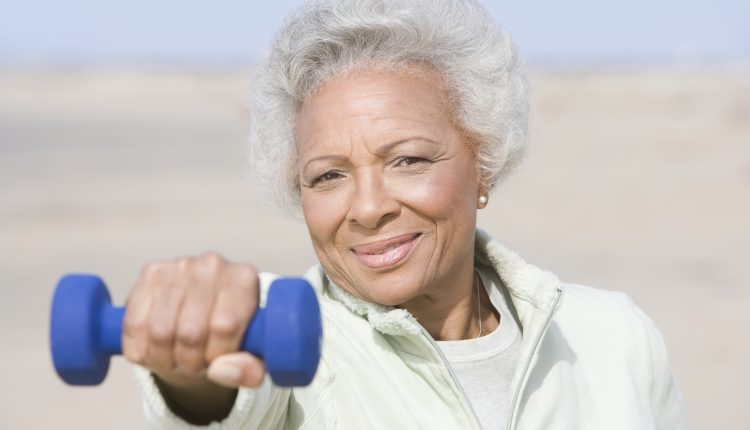 Portrait,An,African,American,Senior,Woman,Exercising,With,Dumbbells,At