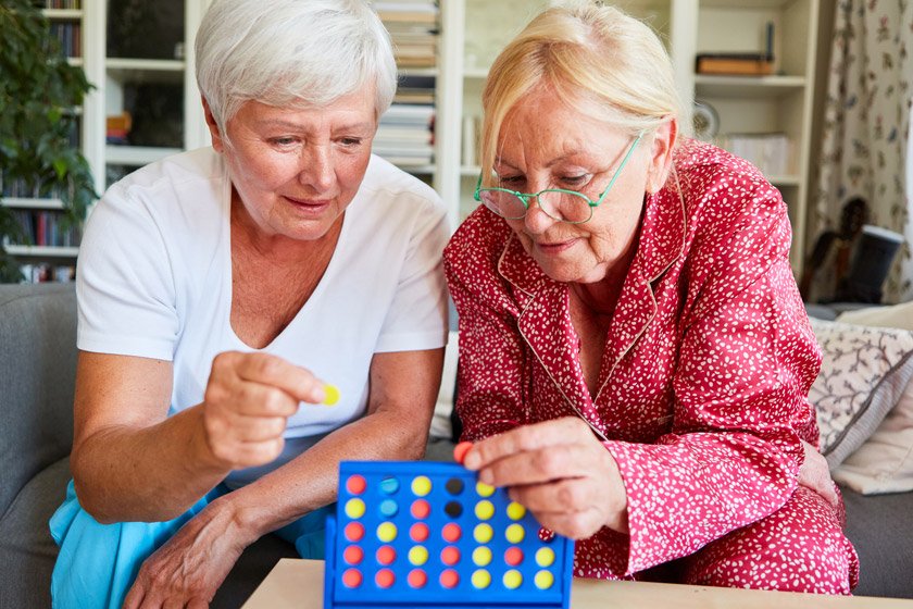 Two senior woman playing a brain game