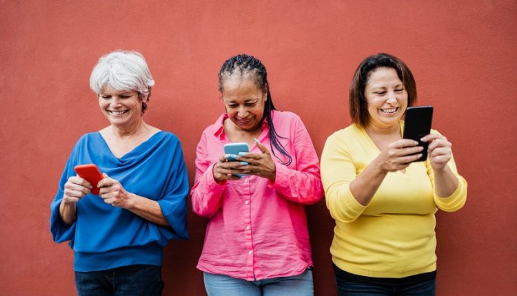 three seniors are checking their online communities