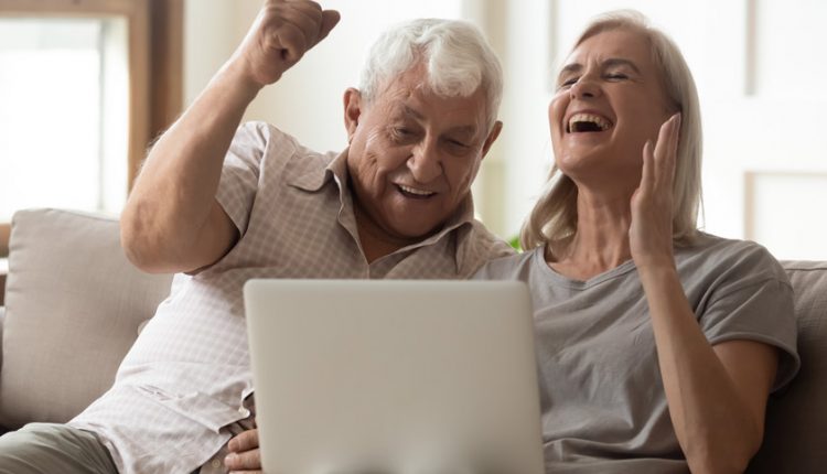 senior couple cheering over a video game