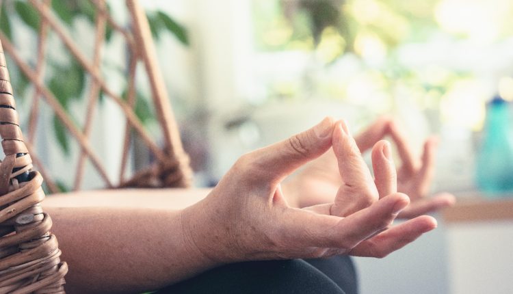Hands of a woman doing yoga