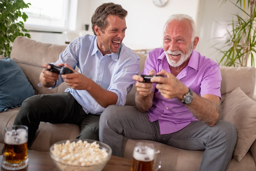 Portrait of two excited men playing video game at home.