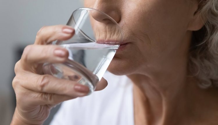 An elderly drinking water