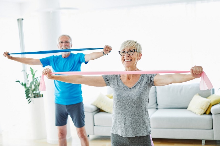 Senior couple exercise together at home health care