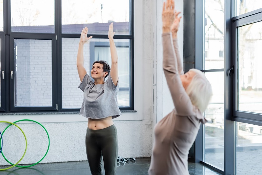 Happy senior woman practicing mountain pose.