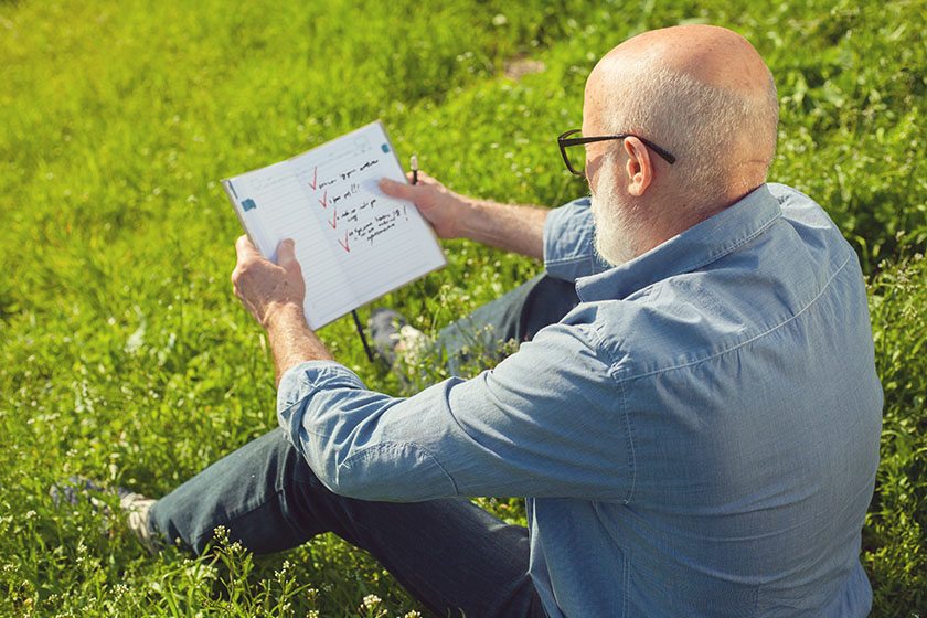 Senior man reading his to-do list for time management